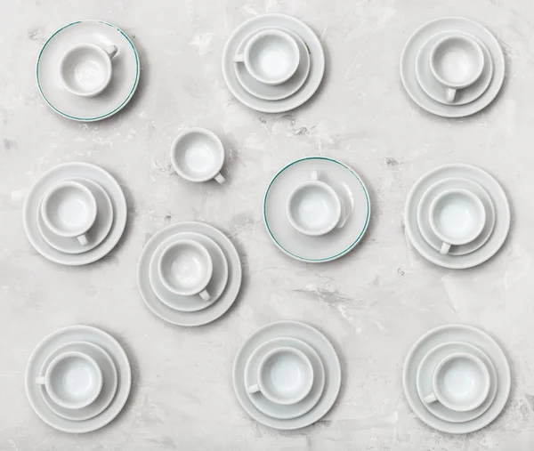 Top view of many cups on saucers on concrete board — Stock Photo, Image