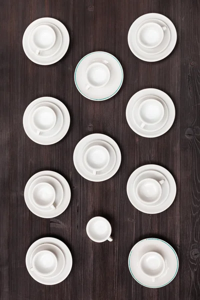 Top view of cups and saucers on dark brown table — Stock Photo, Image