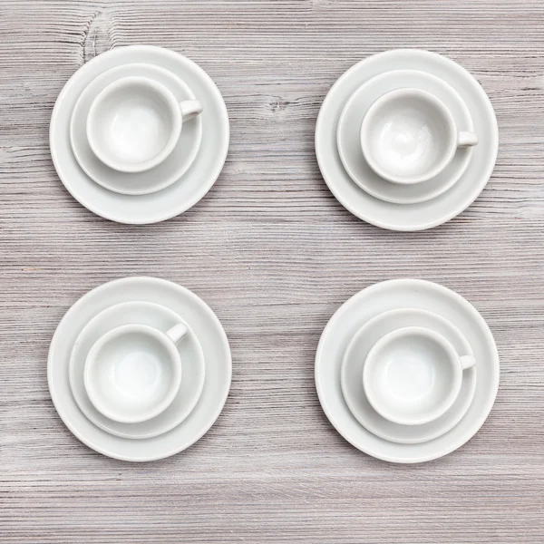 Top view of four cups and saucers on gray board — Stockfoto