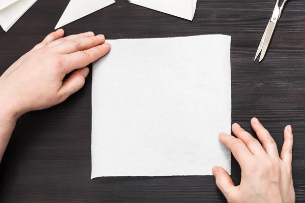 Hands hold blank piece of paper on table — Stock Photo, Image