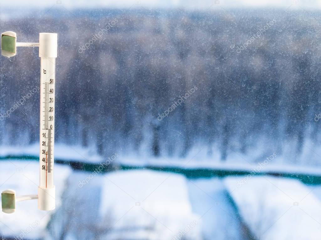 thermometer on home window in cold winter day