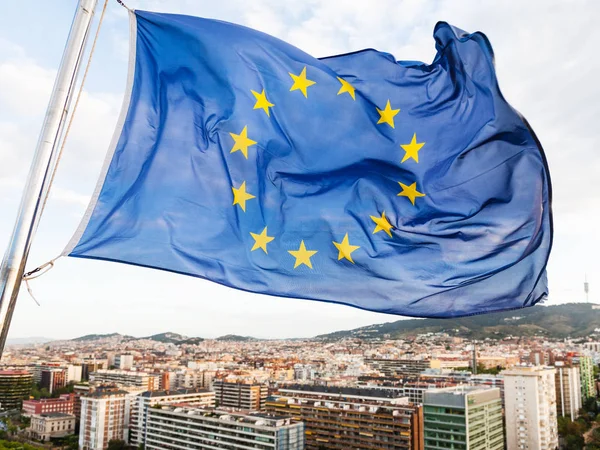 Bandera de la UE ondea sobre casas en la ciudad de Barcelona —  Fotos de Stock