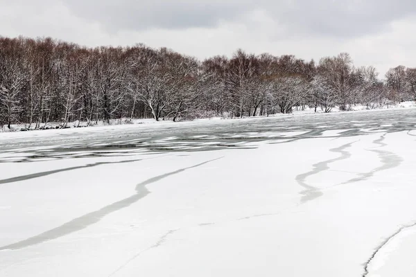 Cracked ice surface of frozen river — Stock Photo, Image