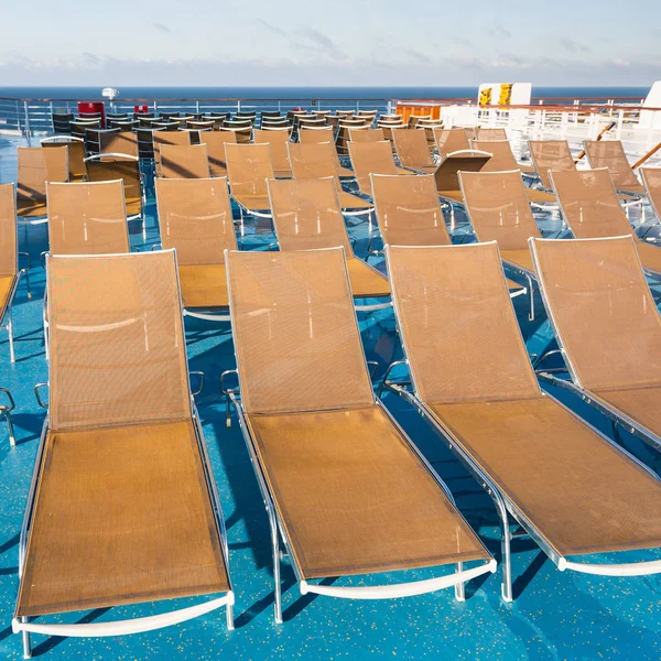 Many empty sunbathing chairs on upper deck — Stock Photo, Image