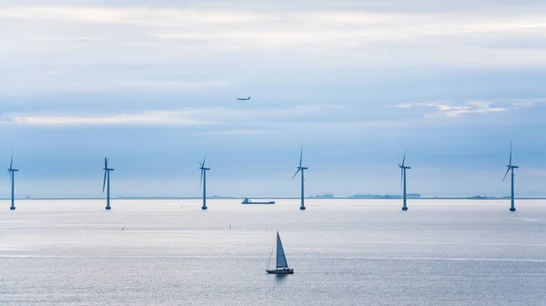 Yacht, ship, airplane and offshore wind farm — Stock Photo, Image