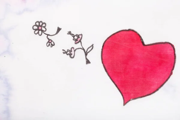 Rött hjärta och blommor nära upp hand — Stockfoto