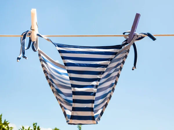 Striped swimming panties is dried on clothesline — Stock Photo, Image