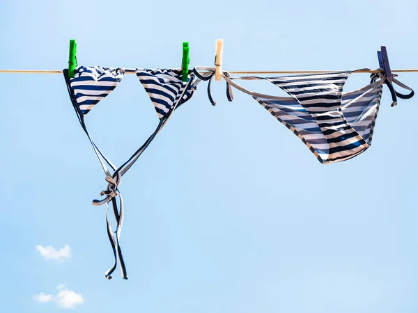 Gestreifter Badeanzug wird an der Wäscheleine getrocknet — Stockfoto