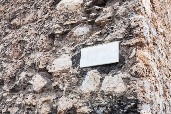 Marble plate on outdoor stone wall in Sicily — Stock Photo, Image