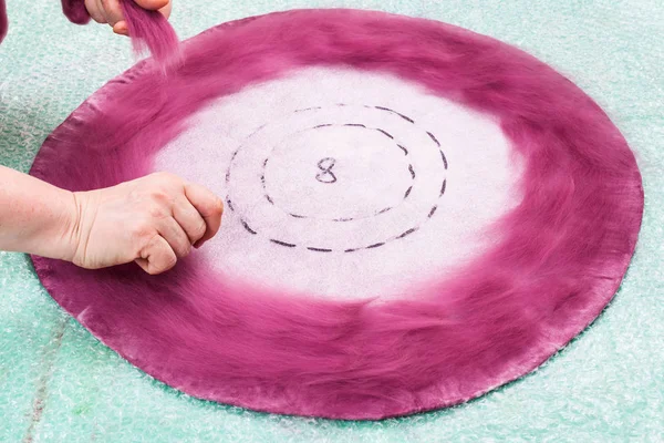 Hatter spreads fibers on back side of hat layout — Stock Photo, Image