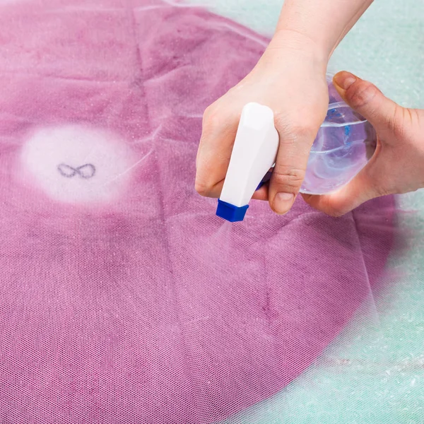 Wetting the wool fibers on back side of hat layout — Stock Photo, Image