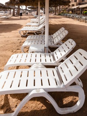 empty chairs on beach in Aqaba city in winter