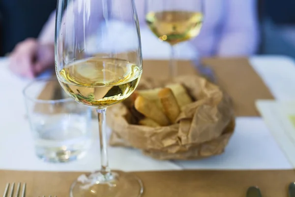 Glass of white wine on a table in a restaurant — Stock Photo, Image