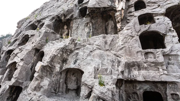 Carved figures and caves in slope of West Hill — Stock Photo, Image