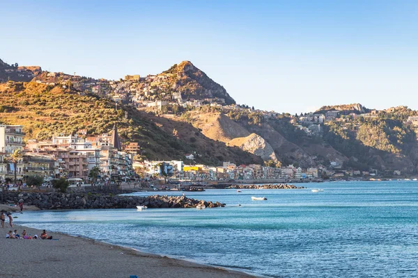 Plaży miejskiej w Giardini-Naxos i widok miasta Taormina — Zdjęcie stockowe