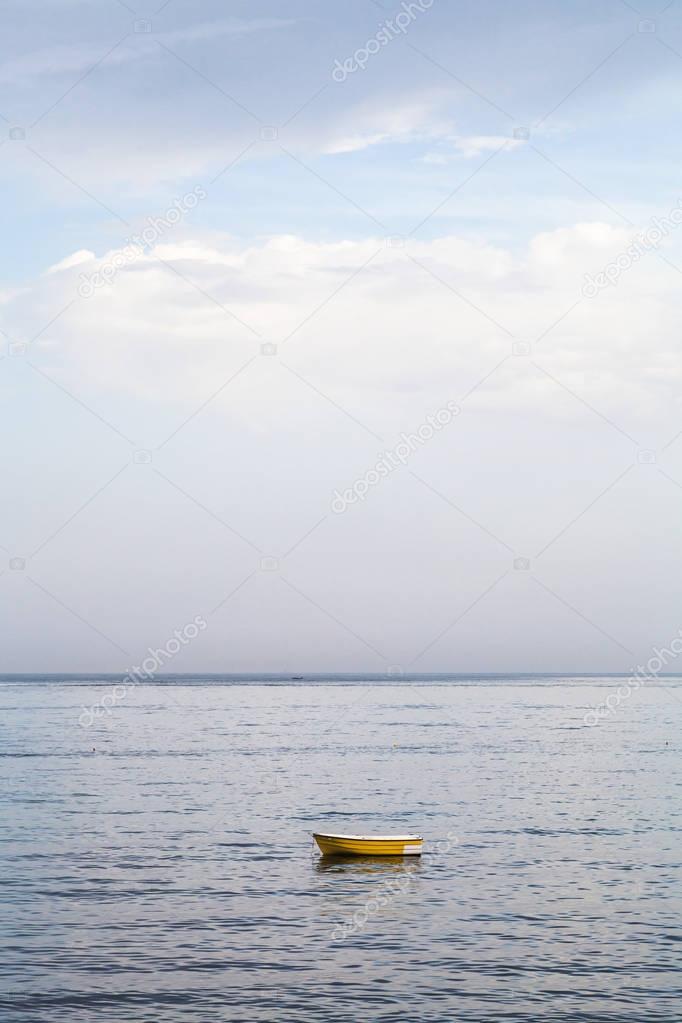 one yellow boat in Ionian sea near Giardini Naxos