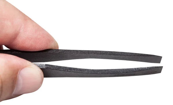 Male fingers hold black plastic flat tweezers — Stock Photo, Image