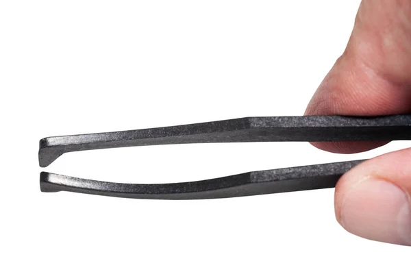 Male fingers hold black plastic tweezer — Stock Photo, Image