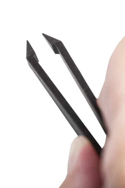Above view of male fingers holding black tweezers — Stock Photo, Image