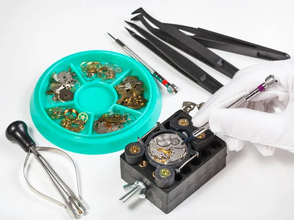 Repairing old mechanical wristwatch on white table — Stock Photo, Image