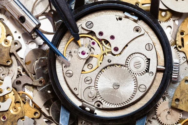 Top view of tools on clockwork on spare parts — Stock Photo, Image