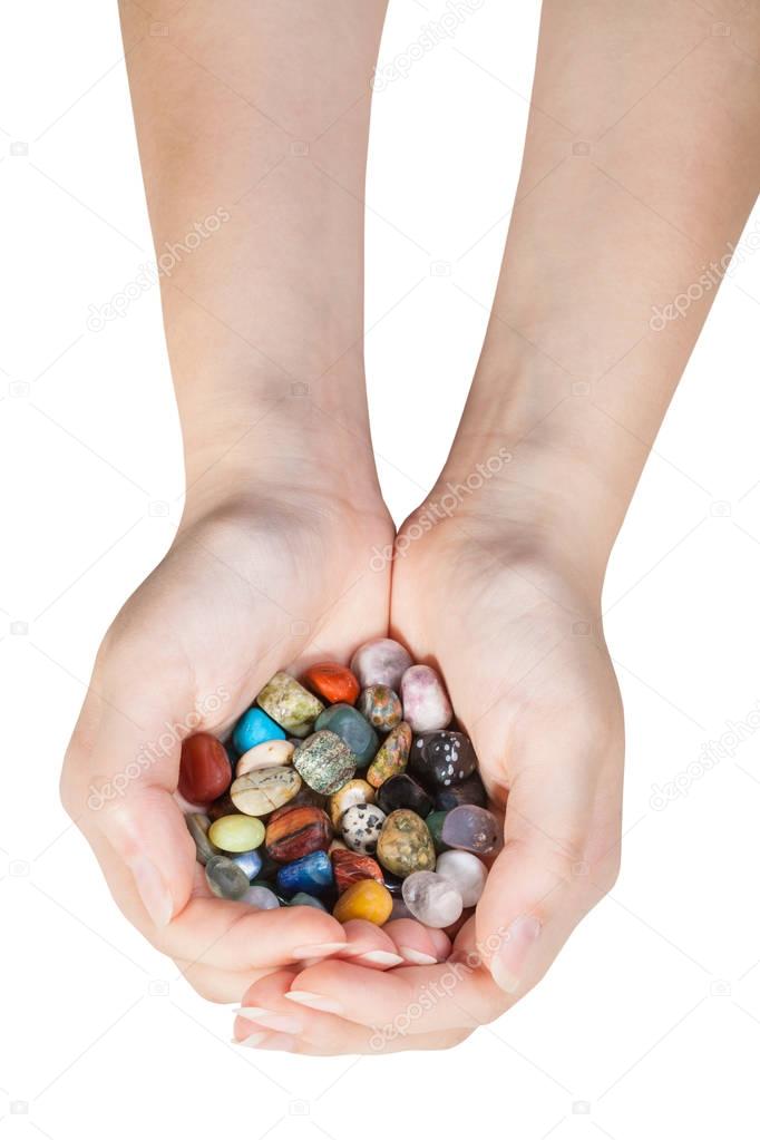 top view of handful with various gemstones