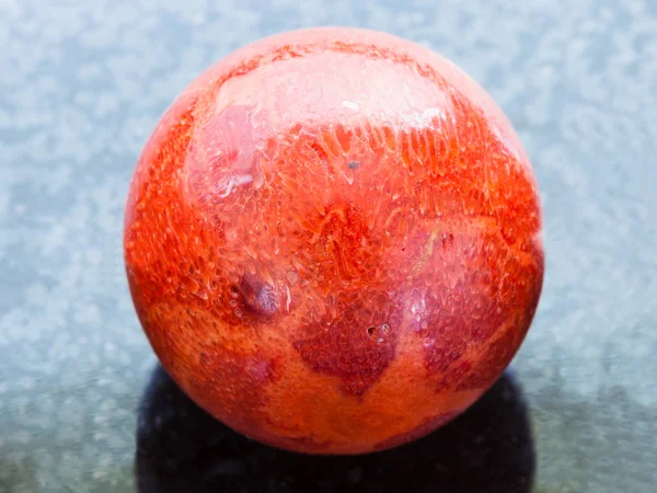 Ball from red Coral gemstone on dark background — Stock Photo, Image