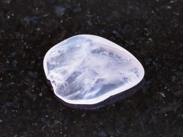 Tumbled pink quartz gemstone on dark background — Stock Photo, Image