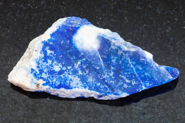 Raw lazurite (lapis lazuli) stone on dark — Stock Photo, Image