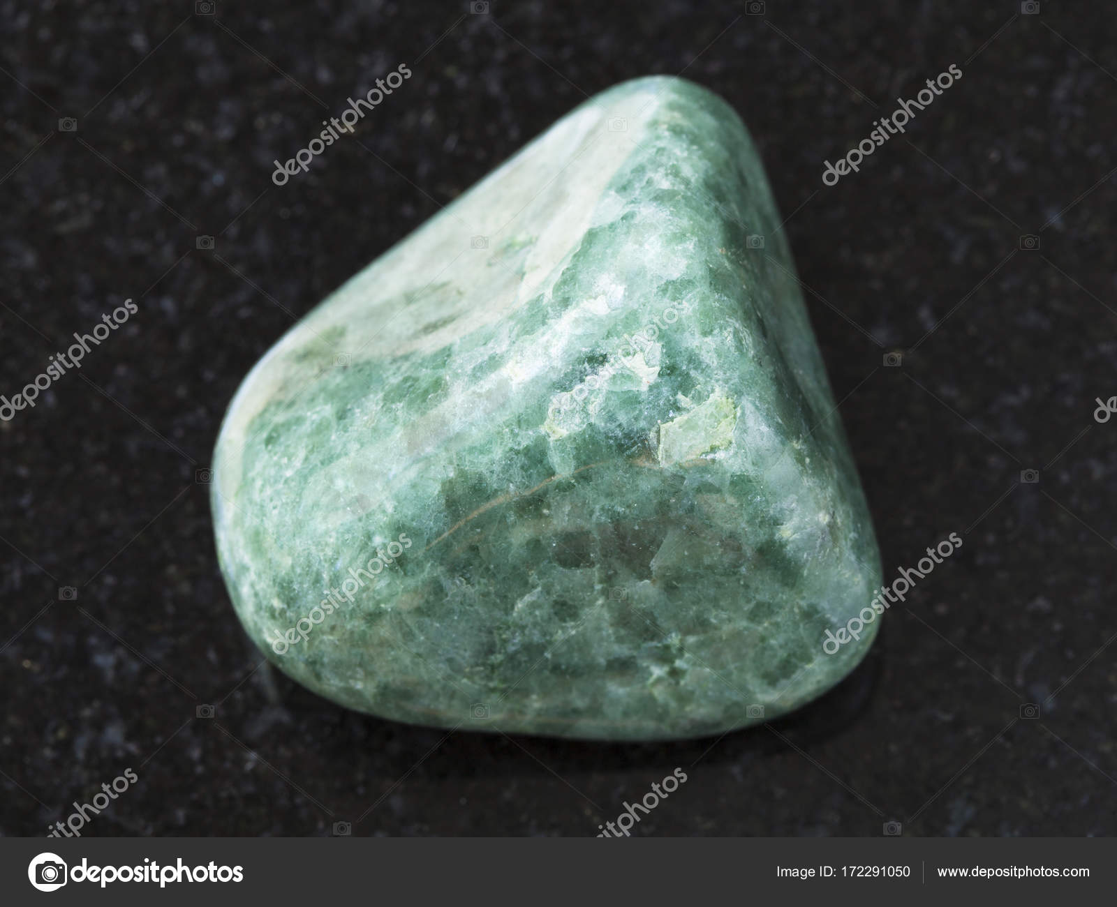Polished green Jadeite gemstone on dark — Stock Photo © vvoennyy 172291050
