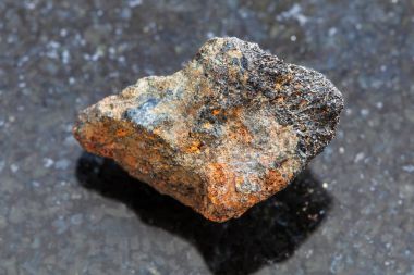 rough Psilomelane (manganese ore) stone on dark clipart