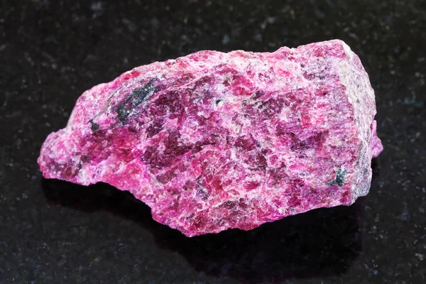 Raw Eudialyte stone on dark background — Stock Photo, Image