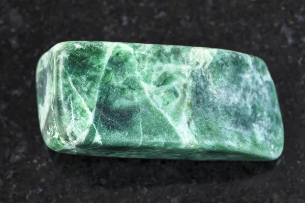 Πεφμένη jadeite πράσινη πέτρα σε σκούρο φόντο — Φωτογραφία Αρχείου