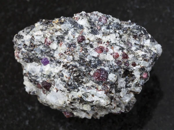 Κορούνδιο τραχιά κρύσταλλα σε γνεύσιους πέτρα στο σκοτάδι — Φωτογραφία Αρχείου