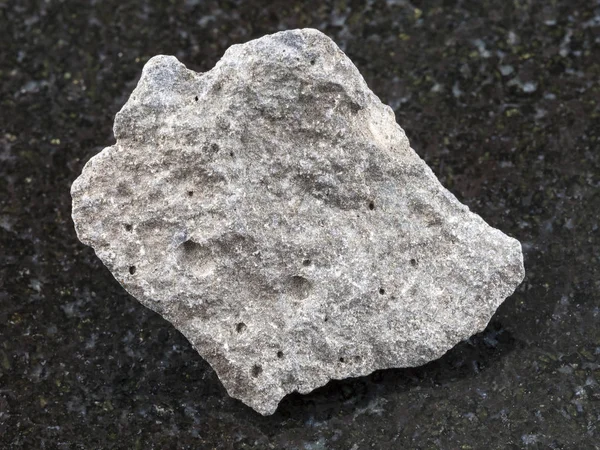 Pebble of gray basalt stone on dark background — Stock Photo, Image
