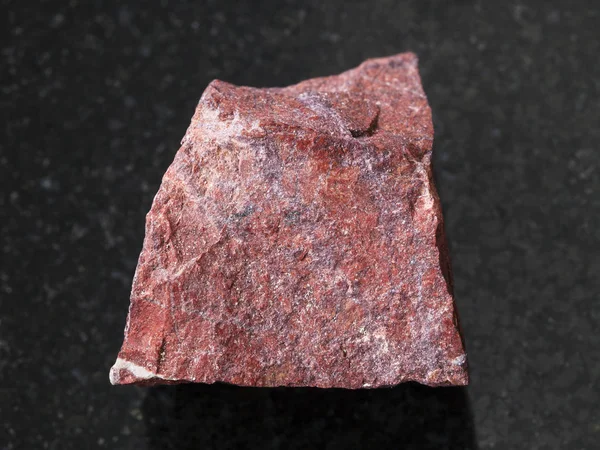 Rough red jasper stone on dark background — Stock Photo, Image