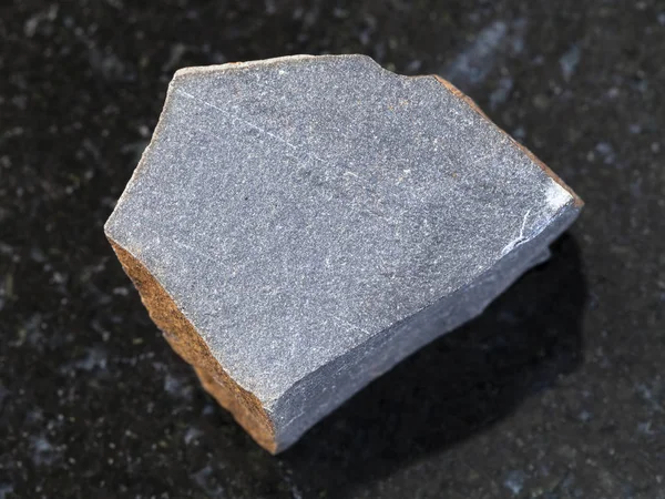 Rough hyalobasalt (tachylite) stone on dark — Stock Photo, Image