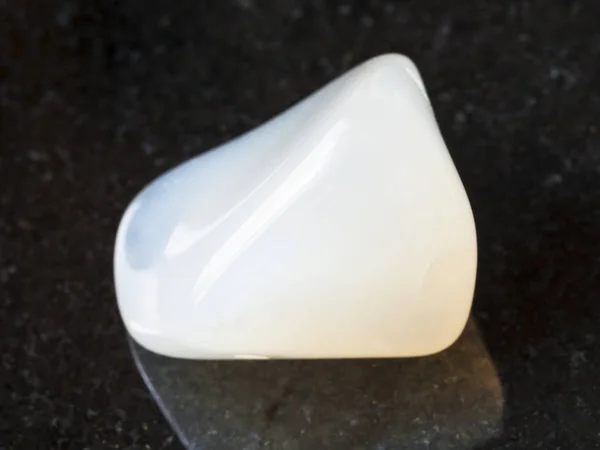 Tumbled white Agate gemstone on dark background — Stock Photo, Image