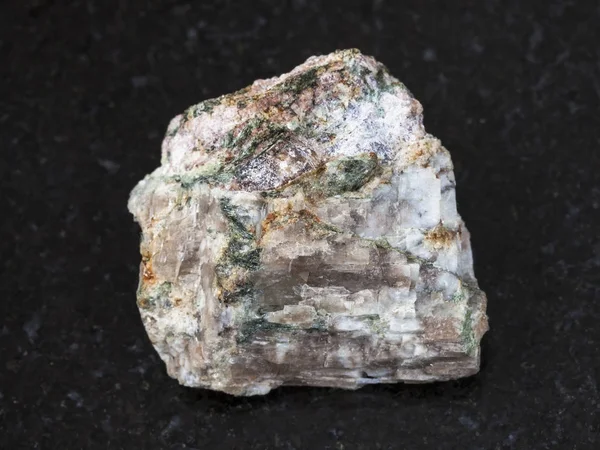 Rough Delhayelite stone on dark background — Stock Photo, Image