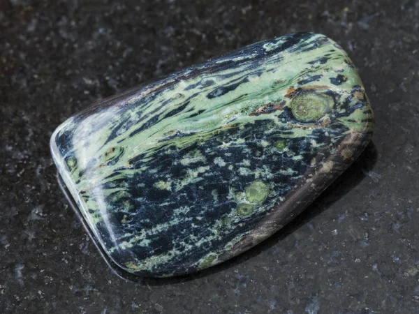 Polished rhyolite gemstone on dark background — Stock Photo, Image