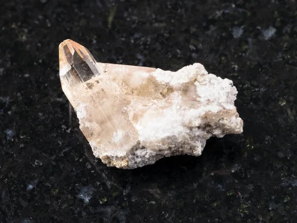 Raw crystal of topaz gemstone on dark background — Stock Photo, Image
