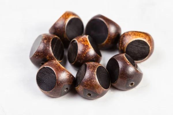 Brown beads carved from natural horn on gray — Stock Photo, Image