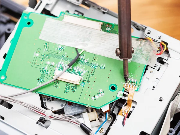 Repairing of circuit board with soldering-iron — Stock Photo, Image