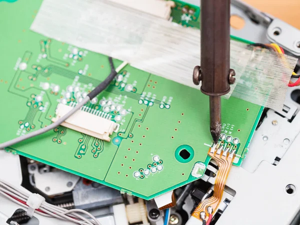 Electric circuit board repair with soldering iron — Stock Photo, Image