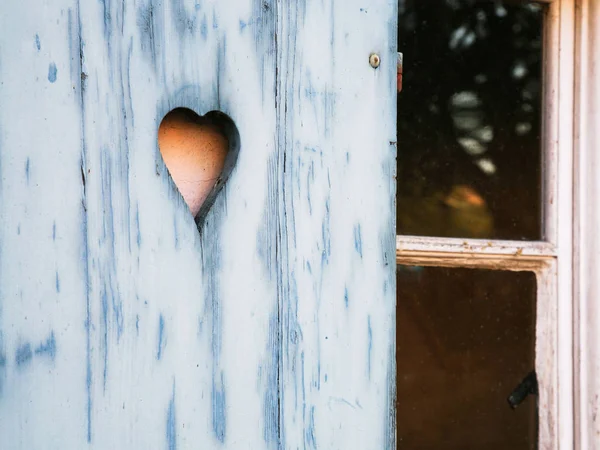 Heart shaped pattern carved in a wooden shutter — Stock Photo, Image