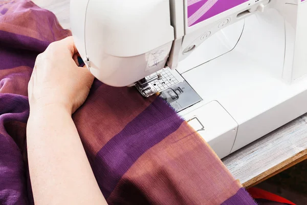 Designer hems strips of fabrics for patchwork — Stock Photo, Image