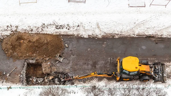 Tractor digging road to change sewer pipes — Stock Photo, Image