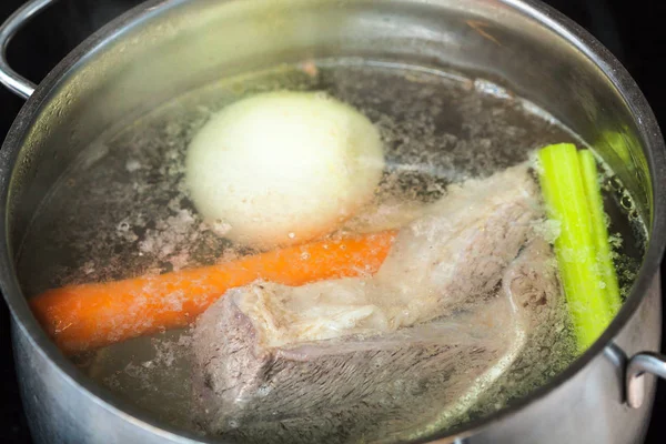 Boiling beef broth in stew pan close up — Stock Photo, Image