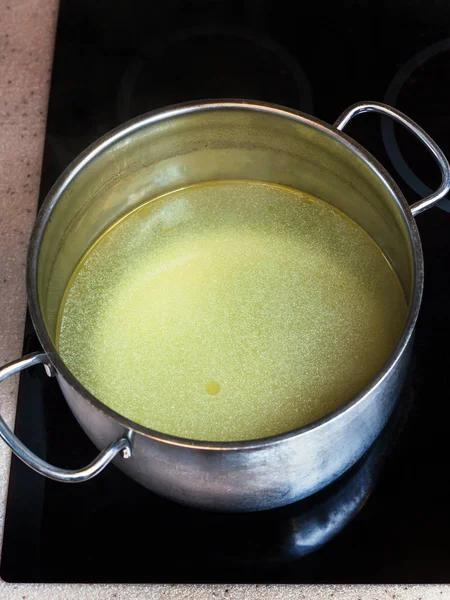 Clear fat meat bouillon in steel stockpot — Stock Photo, Image