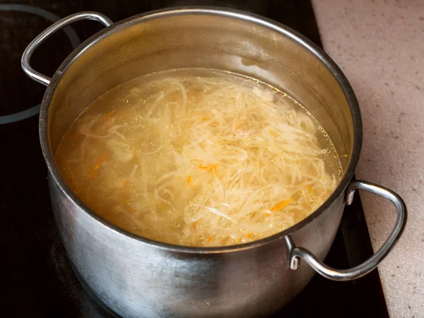 Cabbage soup with stewed sauerkraut in stockpot — Stock Photo, Image